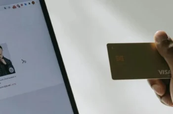 Person holding debit card while browsing ecommerce content with AI or human-written product descriptions