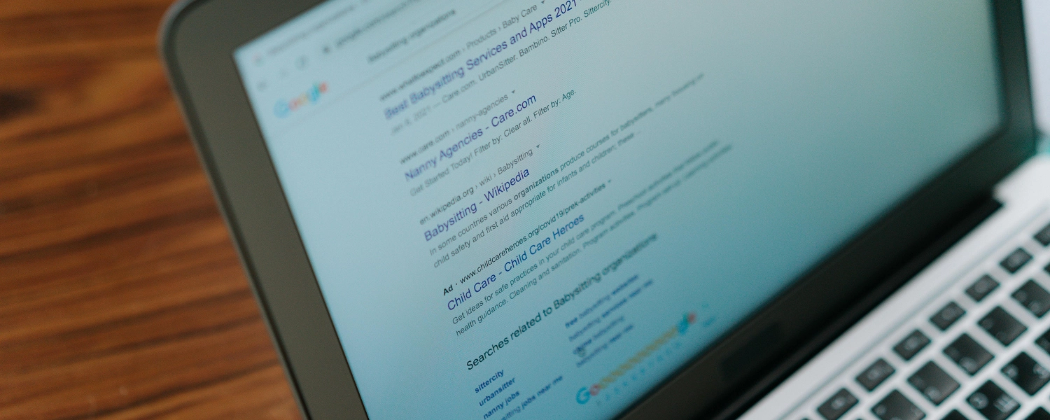 A laptop screen with a google search result for babysitter organisations for seo friendly content